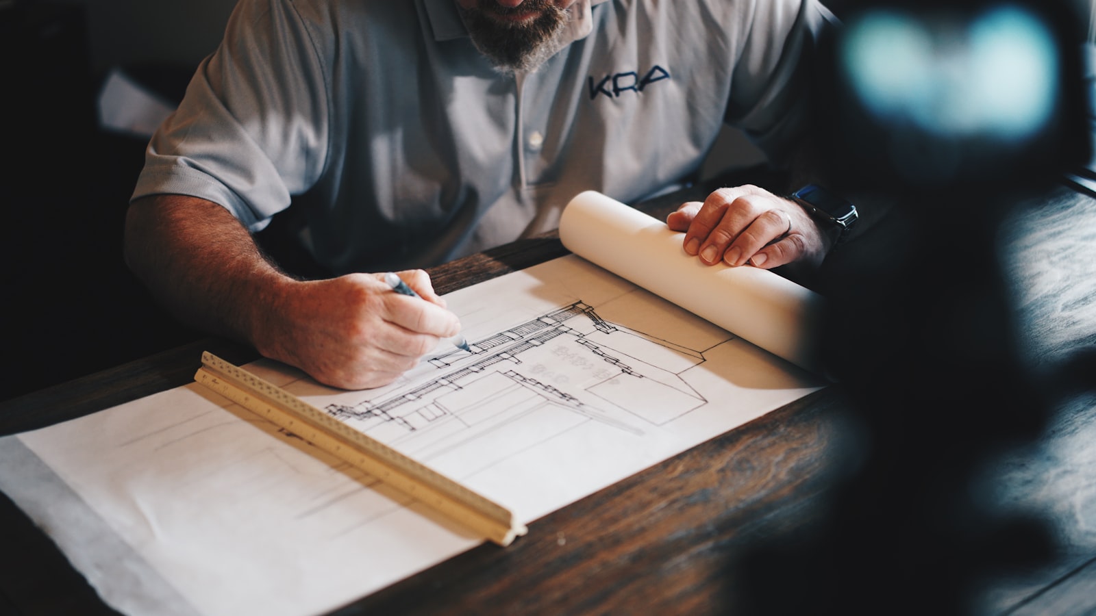 Small-business contractor reviewing plans at his desk — the kind of operator Riley James builds websites for.